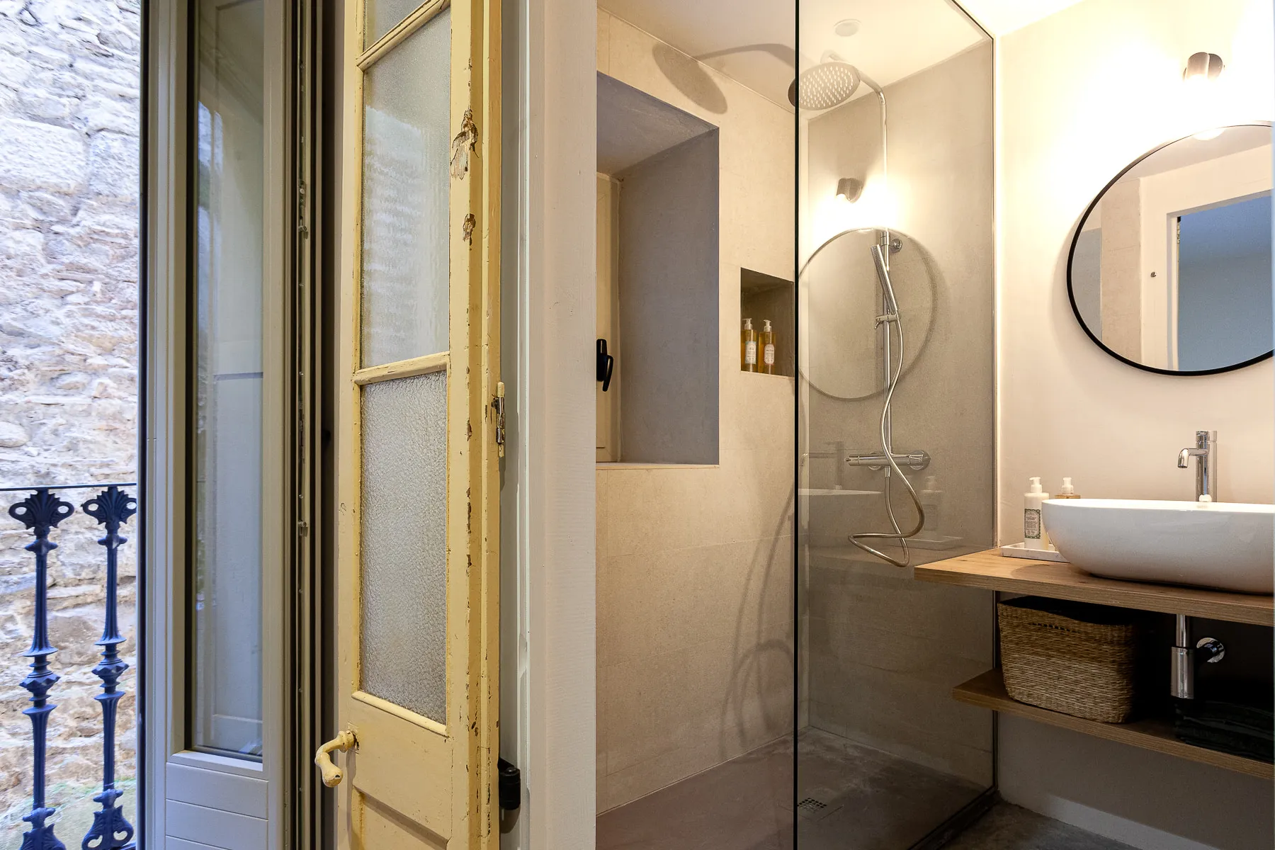 En-suite bathroom with a walk-in shower, round mirror and timber vanity