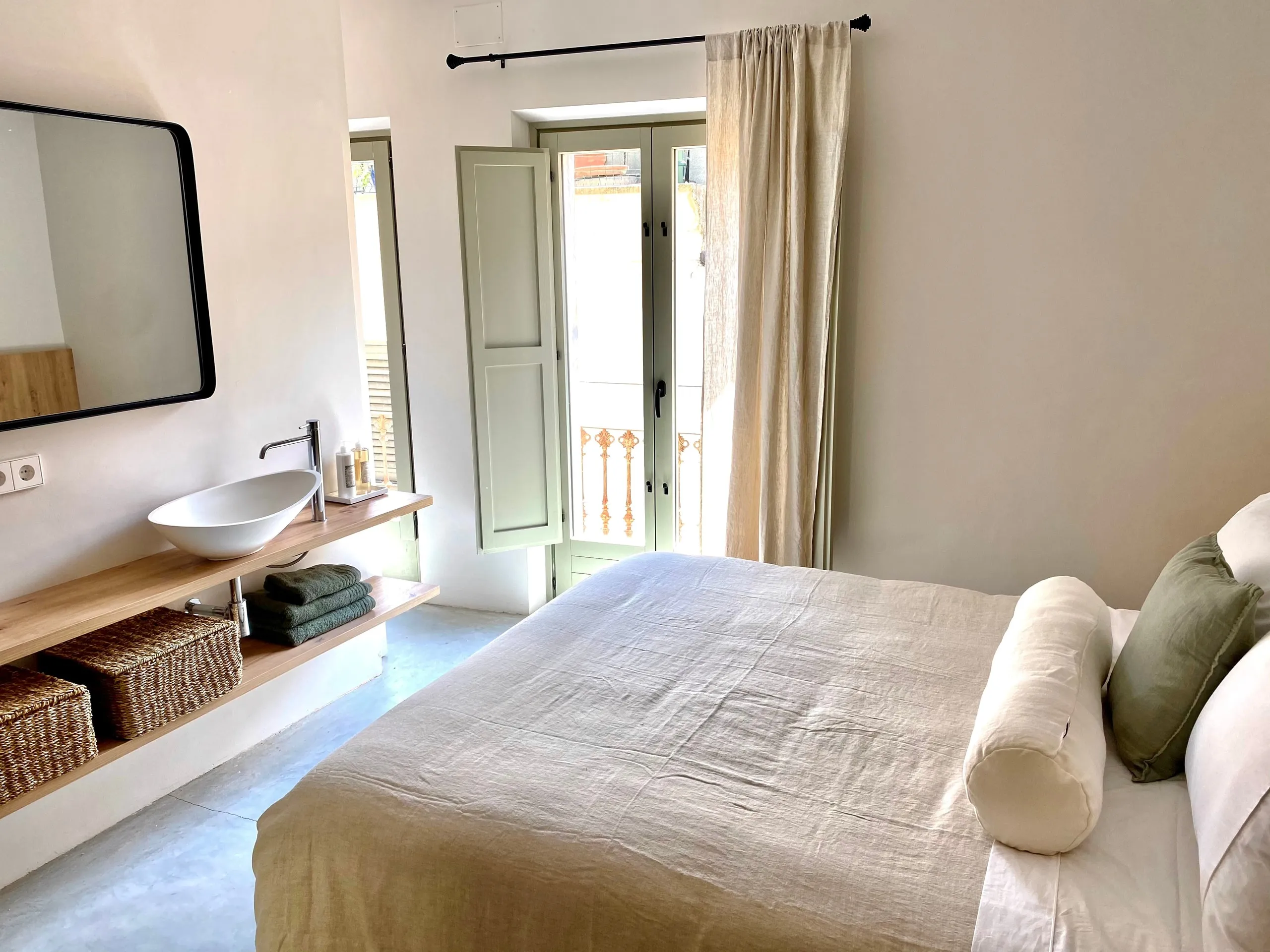 En-suite with a twin basin vanity beside the bed