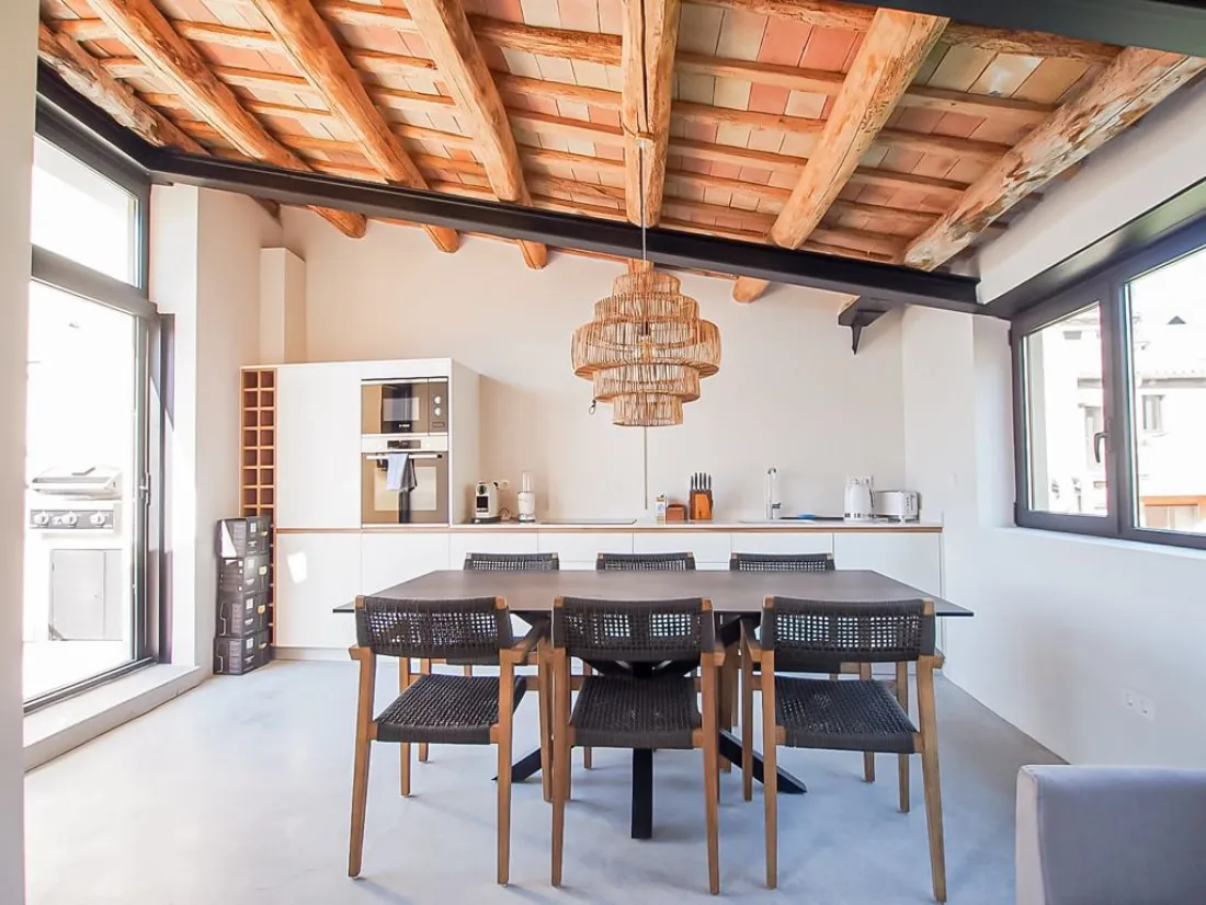 Top-floor dining area beneath exposed timber beams